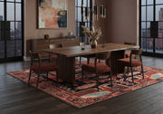 7' x 10' Rectangular Rust Red Black Geometric Medallion Traditional Southwestern Washable Area Rug placed in a dining room with a wooden dining table and rust-colored chairs.
