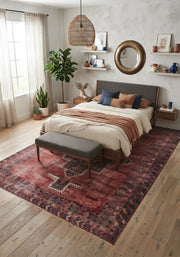 7' x 10' Rectangular Rust Red Charcoal Geometric Medallion Southwestern Traditional Area Rug styled in a bedroom with a gray upholstered bed and matching bench.