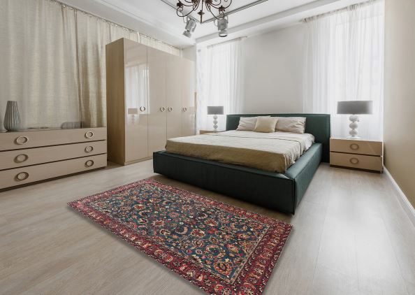 7' x 10' Red Multi Color Floral Traditional Persian Rug placed in an elegant bedroom setting, showcasing the detailed floral medallion pattern and rich red and blue color palette.