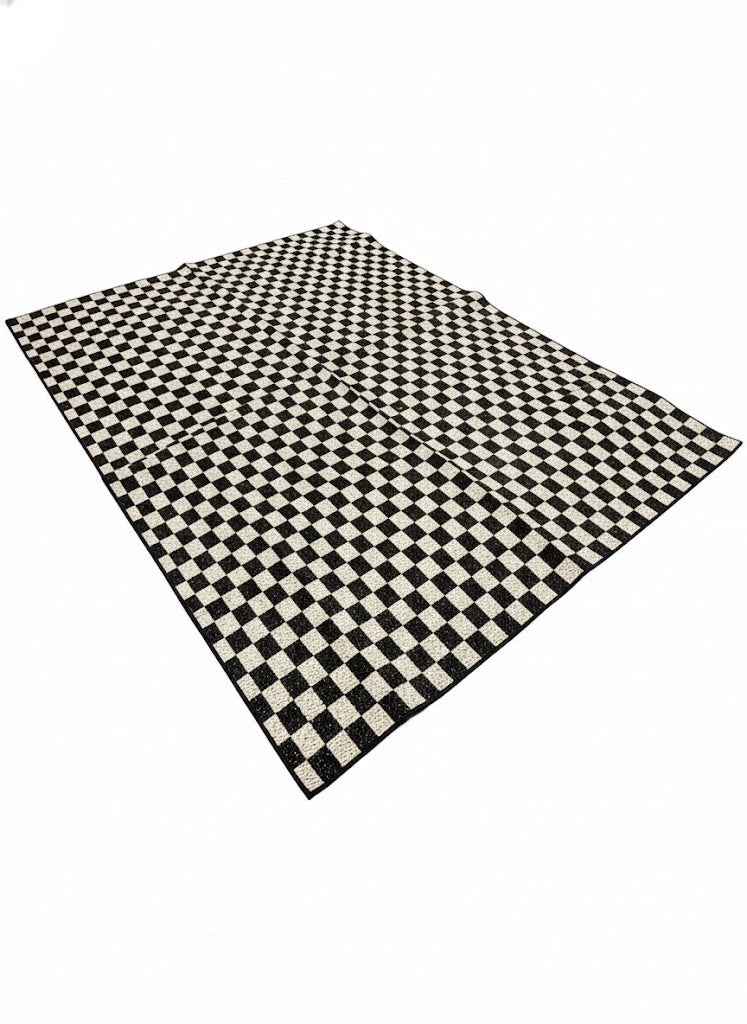 7' x 10' rectangular area rug featuring a black and ivory off-white checkered geometric modern pattern.