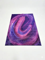 7' x 10' rectangular area rug featuring a bold abstract swirl pattern in shades of purple, pink, and violet.