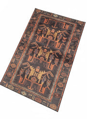 7' x 10' rectangular area rug featuring a charcoal background with burnt orange tribal geometric patterns and a decorative border.