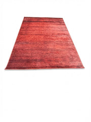 7' x 10' rectangular area rug featuring a distressed vintage design in red, burgundy, and subtle brown tones for a warm farmhouse aesthetic.