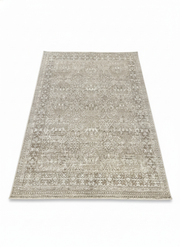 7' x 10' rectangular area rug featuring a neutral warm beige base with pale gray distressed pattern for a soft transitional look.