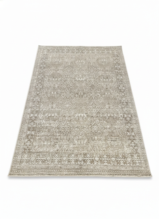 7' x 10' rectangular area rug featuring a neutral warm beige base with pale gray distressed pattern for a soft transitional look.