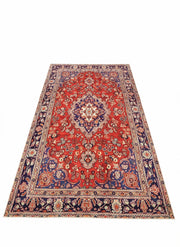7' x 10' rectangular area rug featuring a red base with navy blue and cream floral medallion traditional pattern.