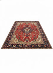 7' x 10' rectangular area rug featuring a red center medallion with navy and cream traditional Persian-style floral motifs and a detailed border.