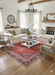 7' x 10' red, navy blue, and cream floral medallion traditional area rug styled in a farmhouse-inspired living room beneath a coffee table and neutral seating.