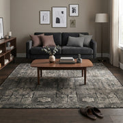 7' x 7' Square Charcoal Gray & Light Gray Distressed Geometric Vintage Washable Area Rug styled in a living room with a dark gray sofa and wooden coffee table.