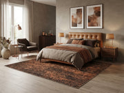 7' x 7' Square Dark Brown & Rust Distressed Abstract Modern Washable Area Rug placed in a bedroom beneath a brown upholstered bed with neutral bedding.