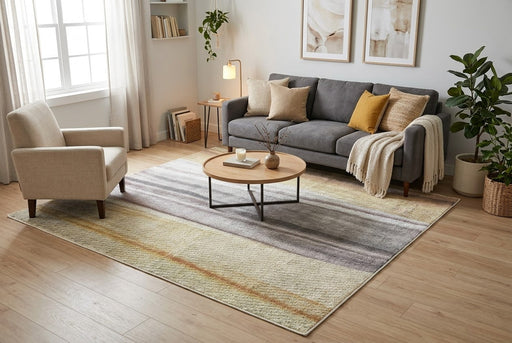 7' x 7' Square Gray Beige & Gold Abstract Striped Modern Area Rug styled in a living room with a gray sofa, cream accent chair, and round wooden coffee table.