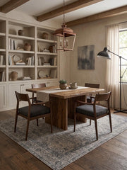 7' x 7' Square Gray & Charcoal Distressed Floral Medallion Vintage Area Rug placed in a dining room beneath a rustic wooden table and upholstered chairs.