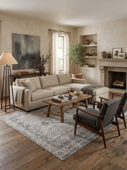 7' x 7' Square Gray & Charcoal Distressed Floral Medallion Vintage Area Rug styled in a living room with a beige sectional sofa and wooden coffee table.