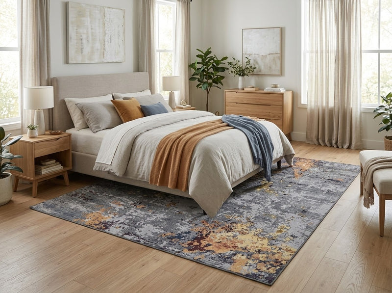 7' x 7' Square Gray Gold & Rust Distressed Abstract Modern Washable Area Rug placed in a bedroom beneath a cream upholstered bed with neutral bedding.