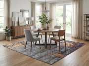 7' x 7' Square Gray Gold & Rust Distressed Abstract Modern Washable Area Rug styled in a dining room beneath a round wooden dining table and upholstered chairs.