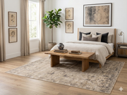 7' x 7' Square Ivory Gray Distressed Medallion Vintage Area Rug placed under a bed in a serene bedroom with layered ivory bedding and warm wood furnishings.