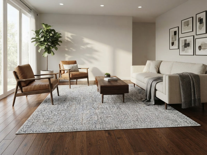 7' x 7' Square Ivory & Light Gray Distressed Textured Modern Washable Area Rug styled in a minimalist living room with a cream sofa, brown leather chairs, and wooden coffee table.