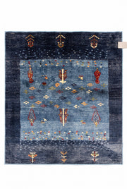 7' x 7' Square Navy Blue & Multicolor Tribal Geometric Southwestern Area Rug featuring a denim blue center, navy border, and colorful tribal motifs in rust, gold, and ivory.