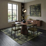 7' x 7' Square Olive Green & Charcoal Distressed Abstract Modern Washable Area Rug styled in a dining room beneath a round wooden table and olive green upholstered chairs.
