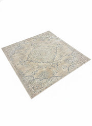 7' x 7' square beige, blue, and light gray vintage medallion area rug featuring a faded traditional pattern with ornate detailing and soft distressed finish.