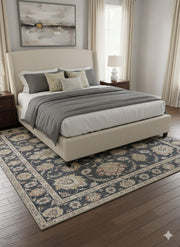 7' x 7' square charcoal floral traditional area rug styled under a bed with neutral bedding and warm wood furniture in a classic bedroom.