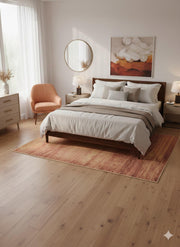 7' x 7' square terracotta and soft beige textured modern area rug placed beneath a wooden bed with neutral bedding and warm accent decor.