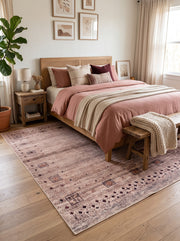 7' x 9' Rectangular Beige Brown Geometric Tribal Southwestern Area Rug placed in a bedroom with a wooden bed, pink bedding, and wooden bench.