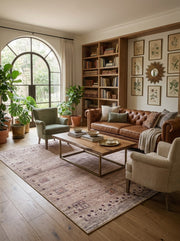 7' x 9' Rectangular Beige Brown Geometric Tribal Southwestern Area Rug styled in a living room with a brown leather sofa, green armchair, and wooden coffee table.