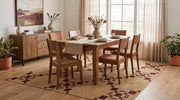 7' x 9' Rectangular Beige Burgundy Diamond Geometric Modern Area Rug styled in a dining room with a wooden dining table and upholstered chairs.
