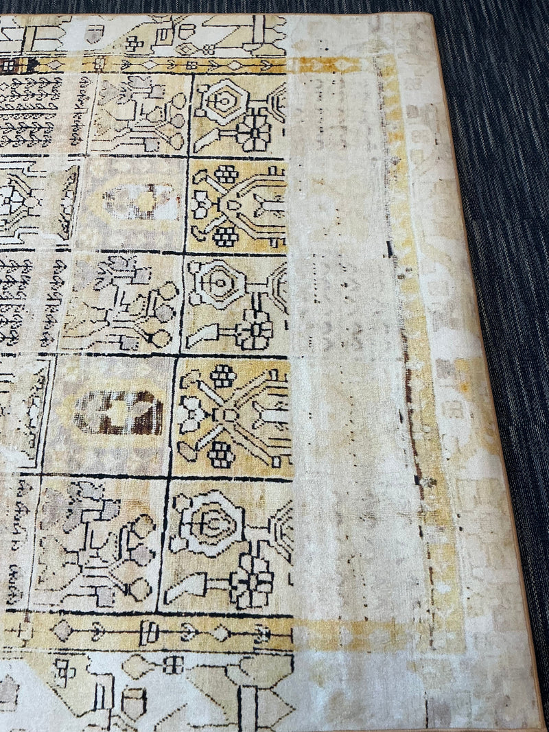 7' x 9' Rectangular Ivory & Gold Tribal Geometric Traditional Area Rug isolated on a white background.