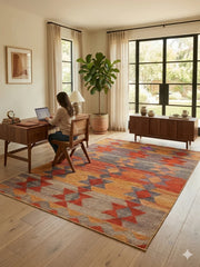 7' x 9' Rectangular Orange Multi Color Geometric Tribal Southwestern Area Rug styled in a home office with a wooden desk and chair.