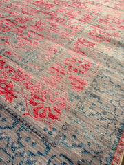 7' x 9' Rectangular Pink & Blue Gray Ivory Distressed Traditional Area Rug shown in a detailed close-up view highlighting the distressed floral pattern and texture.