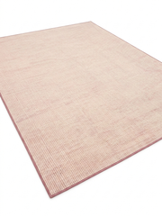 7' x 9' Rectangular Pink Ivory Solid Modern Area Rug shown in a modern living room with neutral sofa, wooden coffee table, and blush accent pillows.