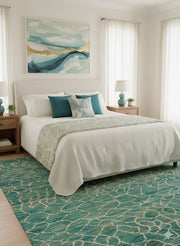 7' x 9' Rectangular Teal Beige Crackled Geometric Abstract Modern Area Rug placed in a bedroom with a white bed, teal pillows, and wooden nightstands.