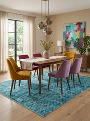 7' x 9' Rectangular Turquoise Blue Multicolor Distressed Diamond Geometric Modern Area Rug styled in a dining room with a wooden dining table and colorful chairs.