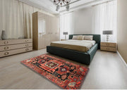 7' x 9' Red Multi Color Traditional Persian Area Rug staged in a modern bedroom setting, showcasing the bold geometric medallion design and vibrant red tones.