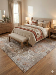 7' x 9' Silver Gray Rust Beige Ivory Abstract Modern Distressed Area Rug placed / styled in a bright neutral bedroom under a light upholstered bed with layered beige and rust accents.
