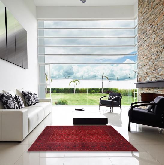 7' x 9' Traditional Red Burgundy Persian Area Rug displayed in a bright modern living room, highlighting the rich red and burgundy tones with classic Persian-inspired geometric motifs.