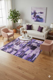 7' x 9' purple geometric abstract modern area rug styled in a living room with neutral sofa, blush accent chairs, and contemporary decor.