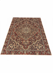 7' x 9' rectangular washable area rug featuring a burgundy, brown, and ivory traditional medallion design with an ornate decorative border.