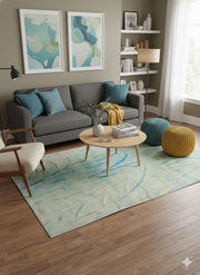 7' x 9' sage green abstract modern area rug placed in a contemporary living room with a gray sofa, teal accent pillows, and light wood coffee table.