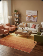 7' x 9' warm orange and golden yellow ombre washable area rug styled in a cozy living room with neutral seating and warm accent décor.