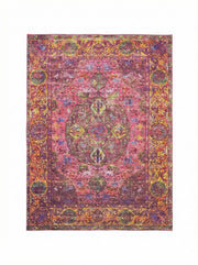 7' x 9' washable area rug featuring a bold raspberry pink base with multi-color bohemian medallion motifs in gold, orange, green, and purple tones with a vintage-inspired distressed finish.