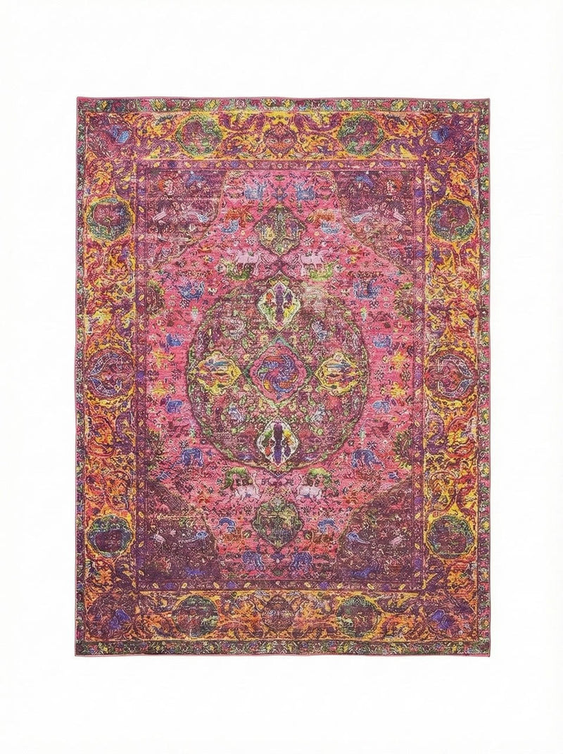 7' x 9' washable area rug featuring a bold raspberry pink base with multi-color bohemian medallion motifs in gold, orange, green, and purple tones with a vintage-inspired distressed finish.