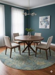 8' Round Blue & Sage Green Distressed Traditional Area Rug styled in dining room under round wooden dining table.