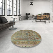 8' Round Dark Khaki Green Traditional Persian Area Rug styled in a modern loft living room, highlighting the intricate Persian-inspired floral motifs and vintage color palette.