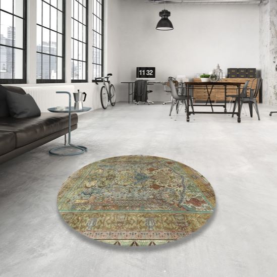 8' Round Dark Khaki Green Traditional Persian Area Rug styled in a modern loft living room, highlighting the intricate Persian-inspired floral motifs and vintage color palette.