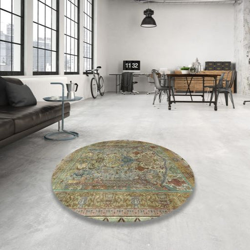8' Round Dark Khaki Green Traditional Persian Area Rug styled in a modern loft living room, highlighting the intricate Persian-inspired floral motifs and vintage color palette.