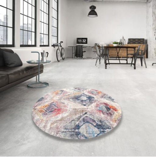 8' Round Ivory Multi Color Contemporary Modern Area Rug styled in an industrial loft living room, highlighting the abstract geometric pattern and soft neutral palette.