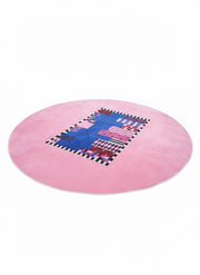 8' Round Pink Royal Blue Black White Geometric Abstract Modern Contemporary Area Rug featuring a pink background, central blue patchwork design, checkerboard accents and zigzag motifs.